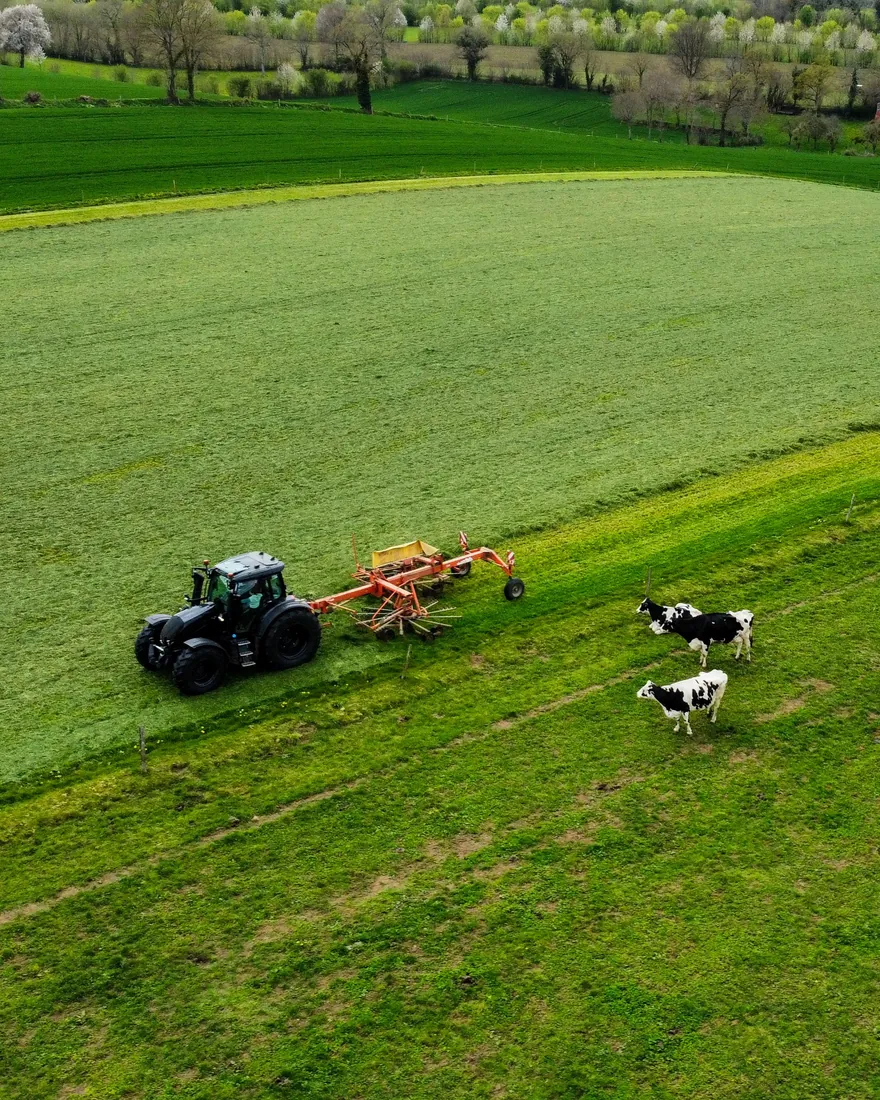 Aerial view of a tractor working a green field