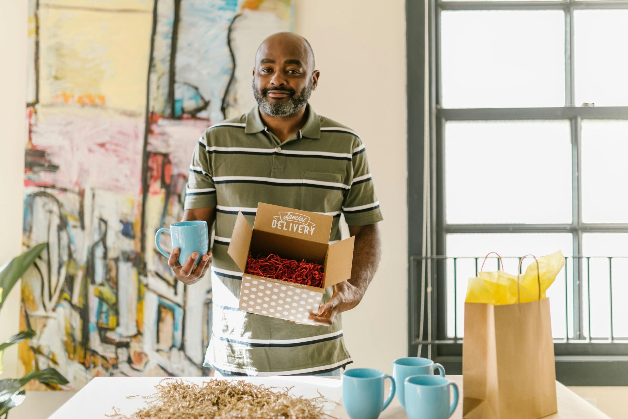 A small business owner standing at the entrance of his shop.