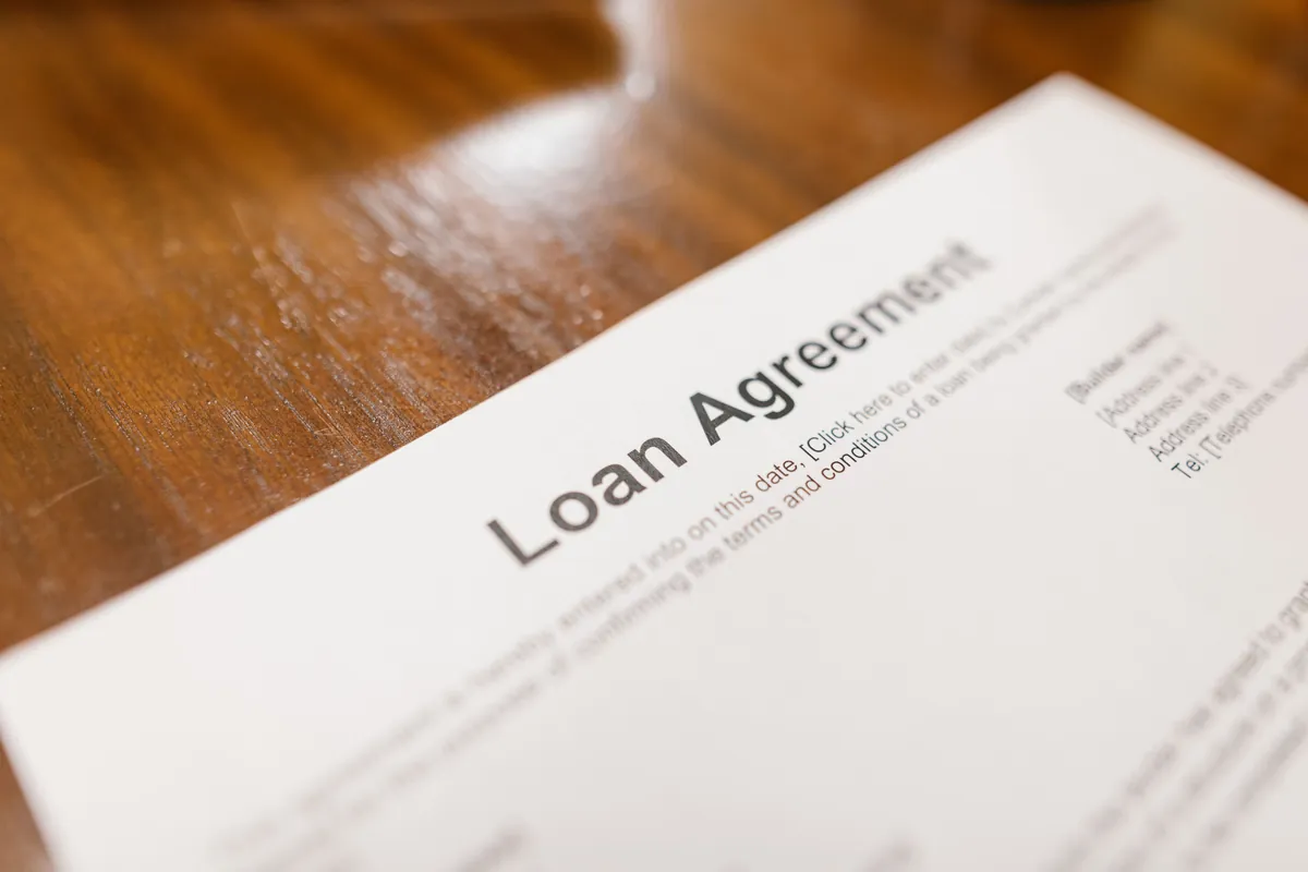 A loan agreement document on a desk