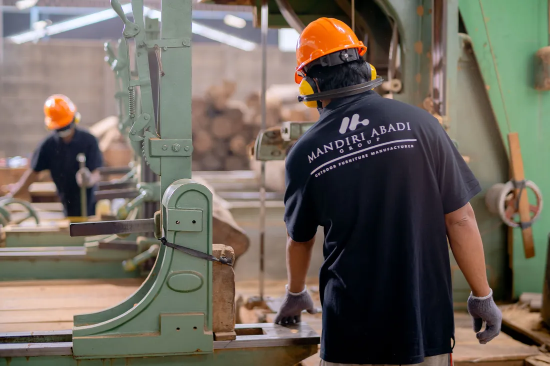 Worker operating equipment on a manufacturing floor