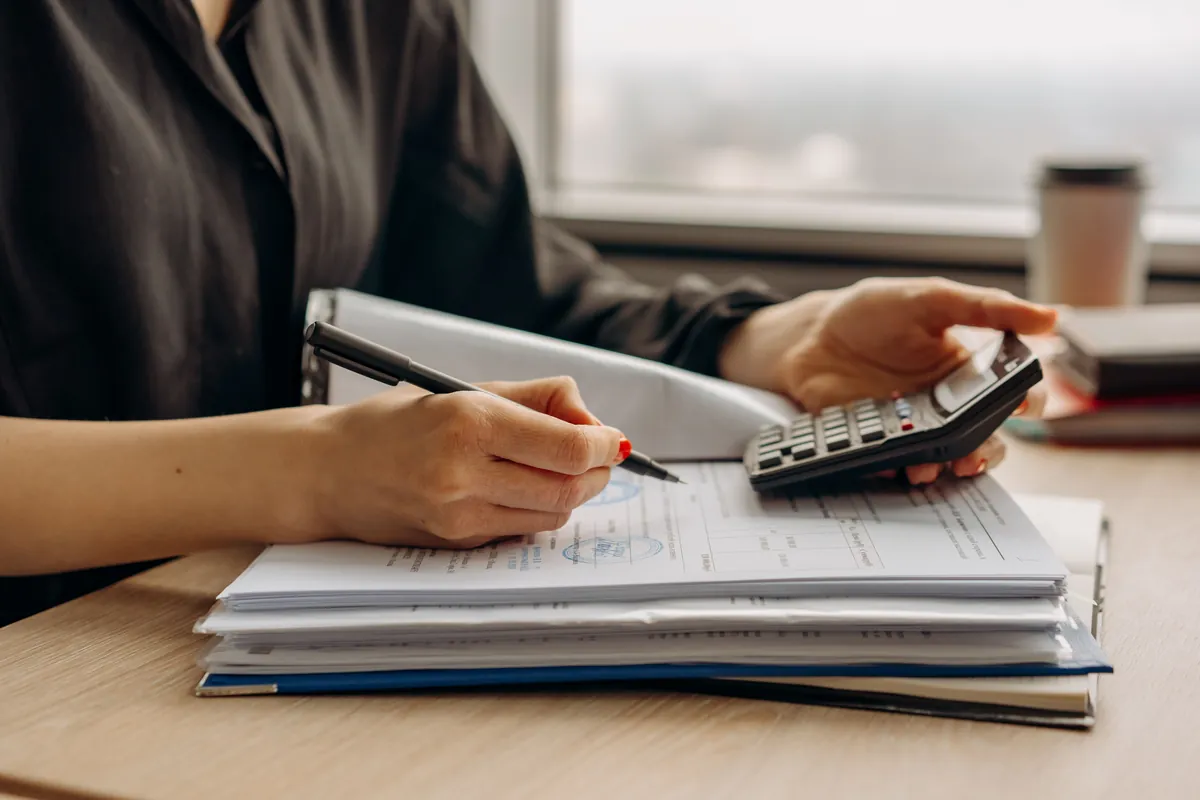 Reviewing financial documents with a calculator
